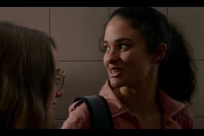 Close-up of two teenage girls conversing in a tiled school corridor, 16 ans 3.