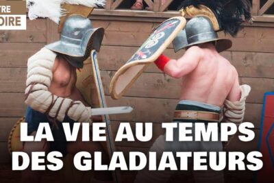 Two helmeted gladiators clash with shields and short swords in a Roman-style reenactment 16 vuotiaiden aanioikeutta 1