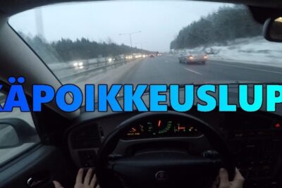Driver's view from inside a car on a snowy highway with hands on the wheel, related to 16 vuotiaiden ajokortin