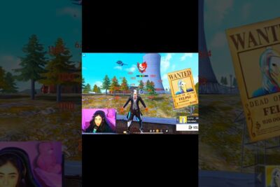 Colorful in-game scene with a masked character, damage indicators and a streamer webcam overlay a definere