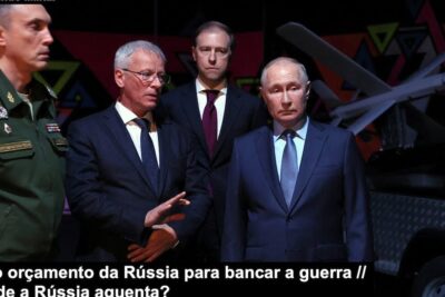 A group of officials and a uniformed military officer observing a drone exhibit while discussing a guerra.