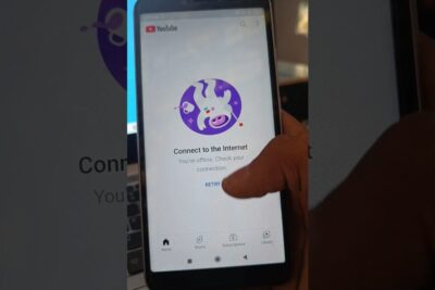 Smartphone screen showing YouTube offline message prompting to connect a internet with a finger near the retry button.