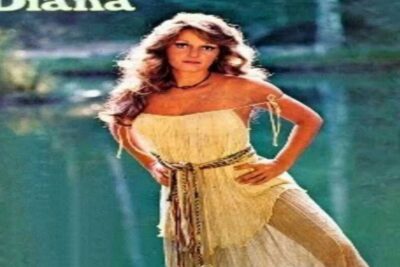 Bohemian woman in a fringed cream dress by a lakeside in a music-themed portrait a musica 1