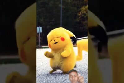 Chubby yellow mascot costume dancing on gravel with a small inset of a man giving a thumbs-up, a vare 8