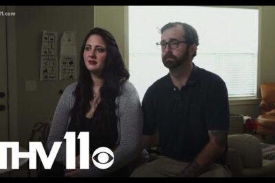 A man and woman sit side by side in a living room during a televised interview with a visible THV11 logo, labeled abort ar 4.