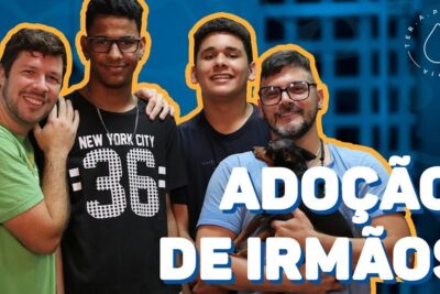 Two men embracing two teenage boys and a small dog in a bright portrait, adocao gay 2.