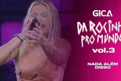 Female vocalist performing energetically into a microphone against a pink promotional backdrop featuring alem disso 53