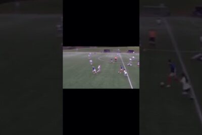 Aerial view of midfield soccer play on artificial turf with players contesting the ball alt skjer.