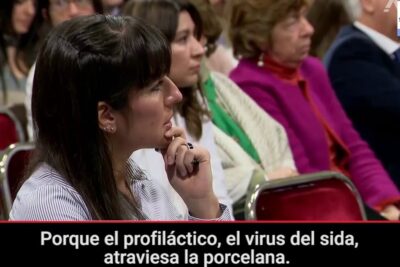 Woman listening intently at a televised senate hearing with visible Spanish subtitles referencing argumentos aborto 3.