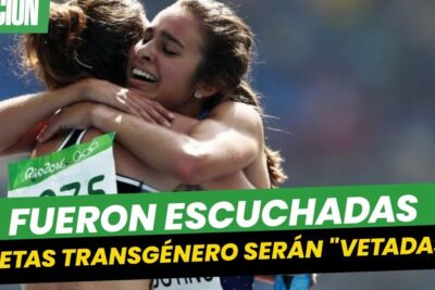 Two female runners embracing after a race with a prominent Spanish headline about atletas transgenero