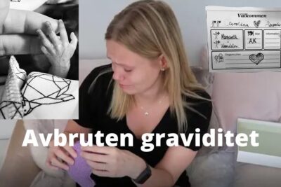 Woman holding a knitted baby blanket and crying, conveying grief after avbruten graviditet.