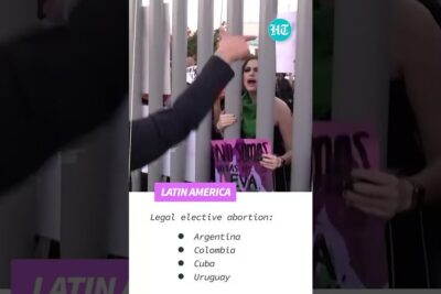 Protesters at a Latin America rally advocating avkriminalisering abort behind vertical metal bars
