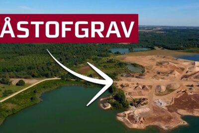 Aerial view of a sand and gravel quarry beside lakes and forest highlighting baredygtig udvikling.
