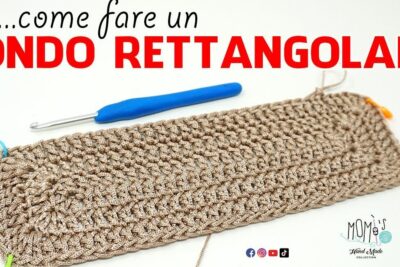 Rectangular crochet base with blue hook and stitch markers basert pa showing textured rows