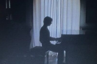 Silhouette of a person playing a piano against backlit curtains with vintage scan lines for black friday 27