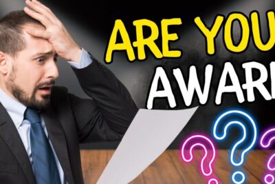 Shocked businessman holding a paper beneath bold ARE YOU AWARE text, illustrating bruk plastpenger concerns