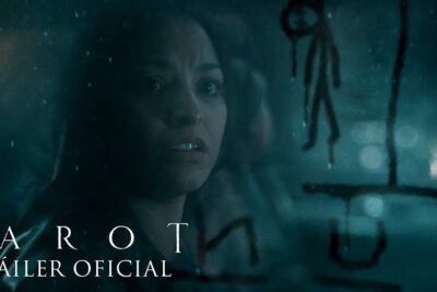 Teal-tinted close-up of a woman gazing through a rain-speckled glass with dark ritual symbols, evocative of cartas tarot 1.