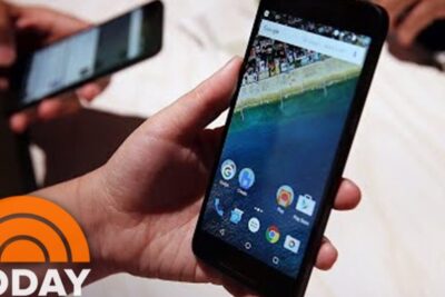 Hand holding a smartphone with app icons visible, illustrating children cellphones.