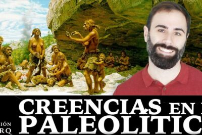 Paleolithic ritual scene by a rock shelter with a smiling presenter discussing creencias religiosas 1.