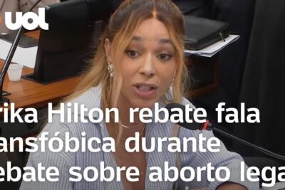 Woman speaking passionately into a microphone during a debate aborto in a formal hearing room