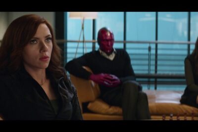 Three seated people in a modern office lounge with a pensive woman in the foreground, evoking diritto decidere.