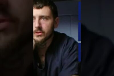 Bearded man in a dimly lit vertical portrait, looking thoughtful — dodsstraffet ar 3.