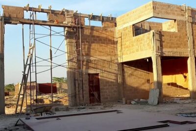 Partially built dun entrepot with scaffolding, concrete columns and exposed blockwork.