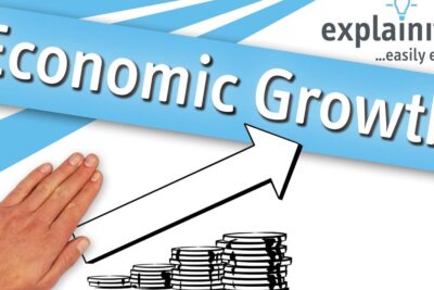 Hand guiding an upward arrow over stacked coins illustrating economic growth 6.