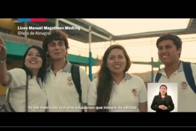 Group of smiling high school students in white polo uniforms standing together representing educacion publica 12.
