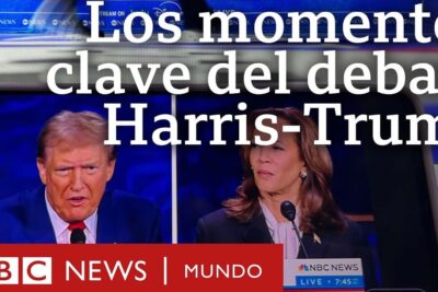 Television screen showing a split-screen of two candidates and a large headline during el debate news coverage.
