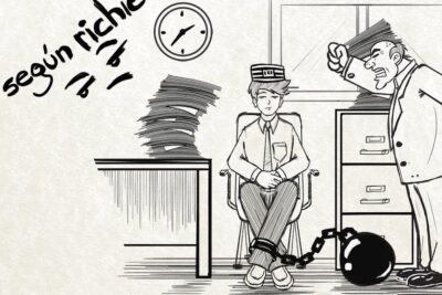 Cartoon of a chained office worker being berated by a boss illustrating el desempleo 1.