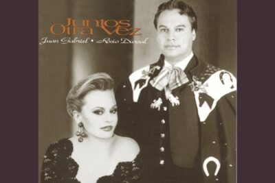 Sepia studio portrait of an elegant couple in formal attire evoking el destino.