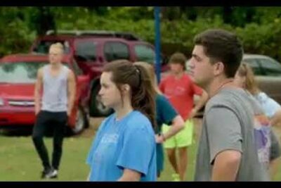 Teenagers standing on a grassy field during a sports gathering highlighting equal opportunities and inclusivity.