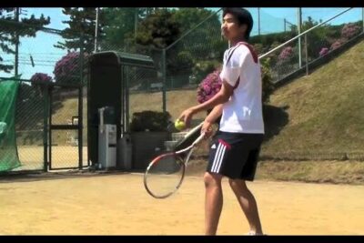 Young tennis player preparing to serve on an outdoor court highlighting ethical implications of fair play