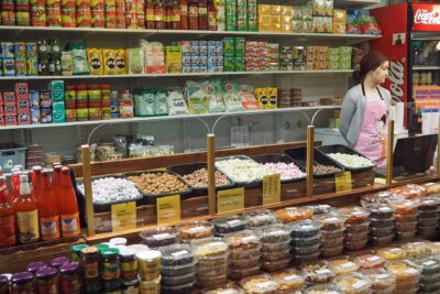 Colorful market counter with assorted sweets, packaged snacks and a space to feature etta jogurtti