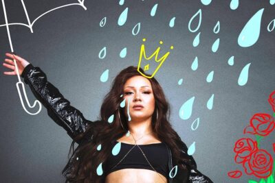 Studio portrait of etta saat posing under drawn raindrops with a crown doodle, umbrella sketch and red rose illustrations