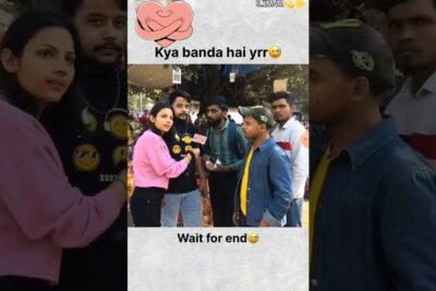 Female interviewer holding a microphone interviewing a group of young men in a candid etta sota street scene