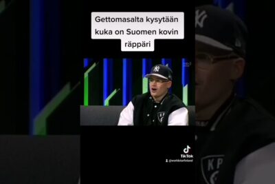 Seated person in a TV studio interview with Finnish overlay text referencing etta valtion 1