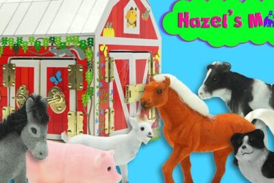 Red toy barn labeled fa barn 1 with gold latches and assorted plush farm animals