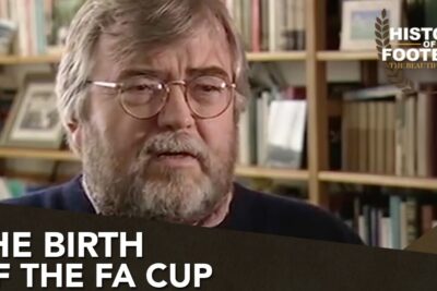 Bearded man interviewed in a study with bookshelves and on-screen title about the FA Cup for fa born 3.