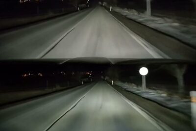 Night highway scene illuminated by fari xenon headlights from a vehicle