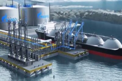 LNG carrier docked at an offshore loading terminal with large storage tanks and loading arms for gas natural 1