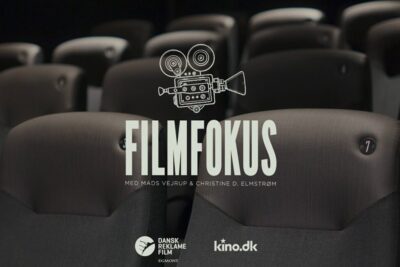 Empty cinema seats with Filmfokus poster and film camera icon promoting an event for hele familien.