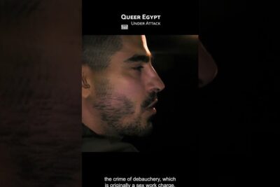 Side profile of a man in a dark news-style frame with the visible headline 'Queer Egypt Under Attack' homofile par 1.
