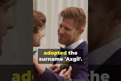 Two grooms, a homoseksuelle par, smiling as one adjusts the other's boutonniere