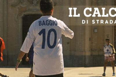 Player in white number 10 jersey playing casual street soccer in a sunlit urban square, il calcio 1.