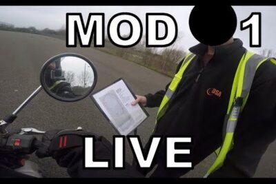 Rider next to a motorcycle with an assessor holding paperwork during an imod tese assessment