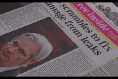 Newspaper front page showing a portrait of an older white-haired man next to a headline about leaks and imod wikileaks.