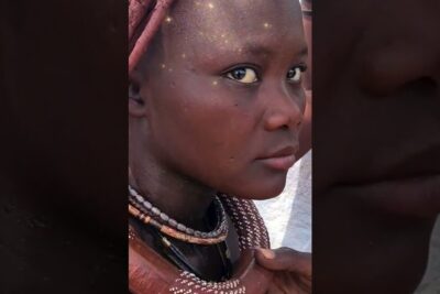 Close-up portrait of a young woman wearing beaded necklaces and a headscarf, indigene volker 1.