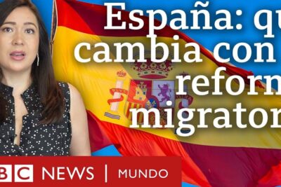 Presenter in front of a Spanish flag discussing inmigracion espana 1 and migration reforms